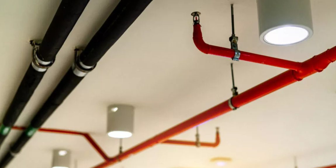 Red piping of fire sprinkler system.